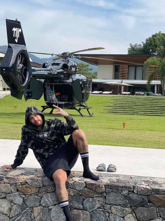 Neymar posa à frente de helicóptero, que tem as iniciais do nome dele na cauda (foto: Reprodução/@neymarjr (Instagram))